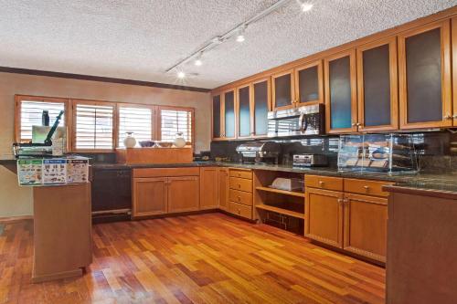 a large kitchen with wooden cabinets and wooden floors at Travelodge by Wyndham Seattle By The Space Needle in Seattle