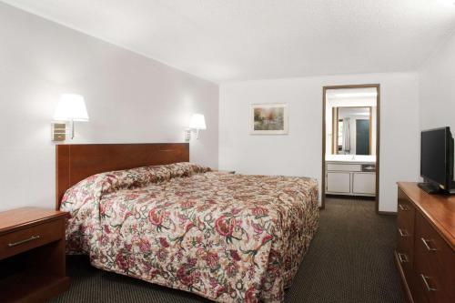 a hotel room with a bed and a television at Knights Inn Pittston in Pittston