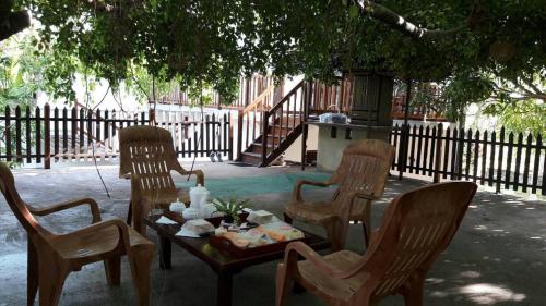a table with two chairs and a table with food on it at Amazing Villa in Matara