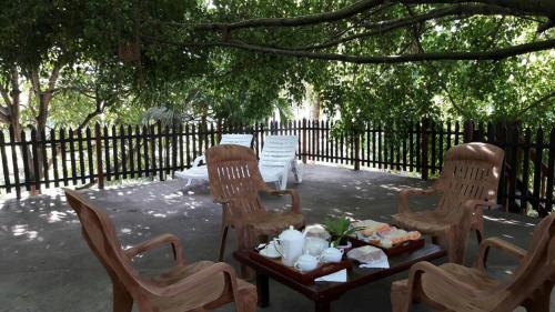 a group of chairs and a table under a tree at Amazing Villa in Matara
