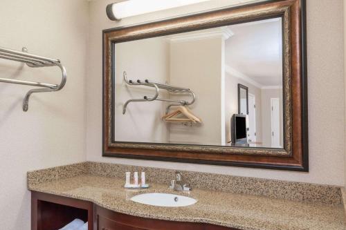 a bathroom with a sink and a mirror at Travelodge by Wyndham Sylmar CA in Sylmar