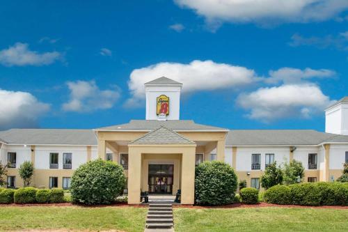 a building with a clock tower on top of it at Super 8 by Wyndham Clemmons - Bermuda Run - Winston-Salem I-40 in Clemmons