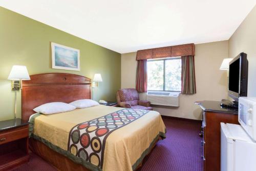 a hotel room with a bed and a television at Red Carpet Inn-Indian Head in Indian Head