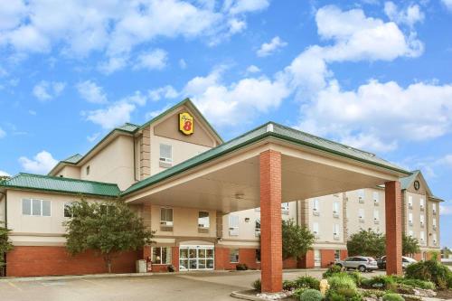 a hotel building with a sign on top of it at Super 8 by Wyndham Edmonton South in Edmonton