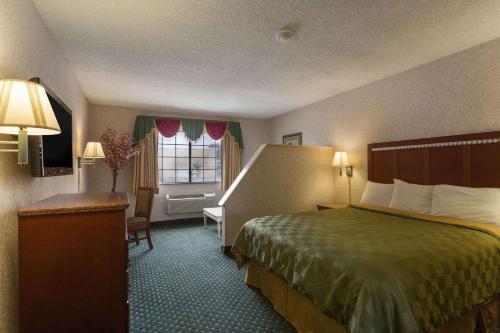 a hotel room with a bed and a window at Triplodge of Santa Clarita in Santa Clarita