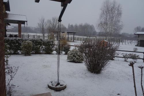 a yard covered in snow with a bird feeder at Agriturismo L'Antico Sapore in Baraggia di Boca