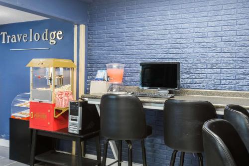 an office with chairs and a desk with a computer at Travelodge by Wyndham Savannah Area/Richmond Hill in Richmond Hill
