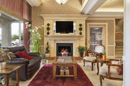 a living room with a couch and a fireplace at Travelodge by Wyndham Edmonton East in Edmonton