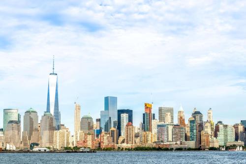 a view of a city skyline from the water at Super 8 by Wyndham North Bergen NJ/NYC Area in North Bergen