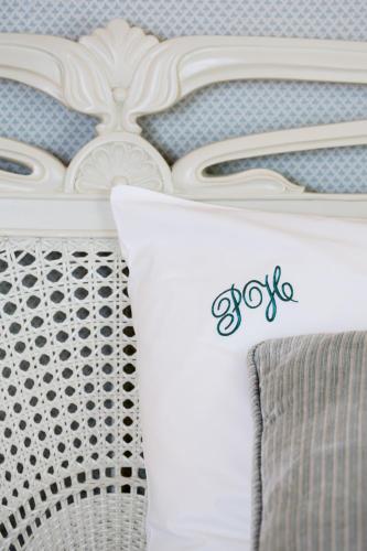 a white bed with a pillow on top of it at Priory Wareham in Wareham