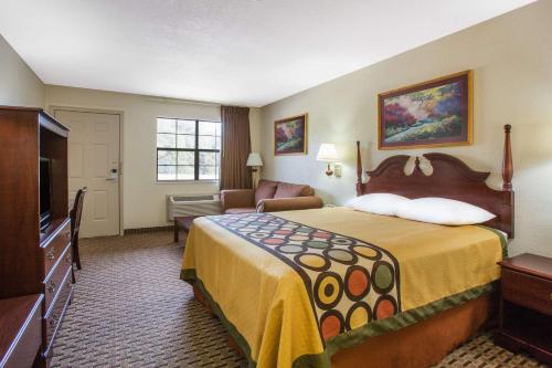 a hotel room with a bed and a television at Super 8 by Wyndham Cabot in Cabot