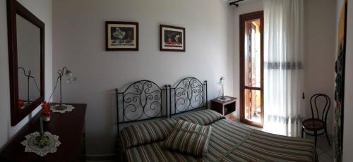 Ένα ή περισσότερα κρεβάτια σε δωμάτιο στο Villa Margherita