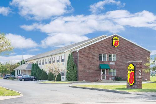 a fast food restaurant with a sign on the side of a building at Super 8 by Wyndham Maumee Perrysburg Toledo Area in Maumee