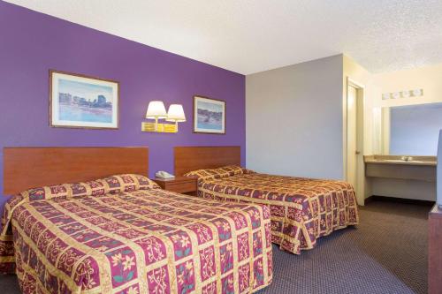 a hotel room with two beds and a sink at Knights Inn Phoenix at N Black Canyon Hwy in Phoenix