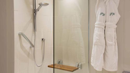 a bathroom with a shower with a glass door at Priory Wareham in Wareham
