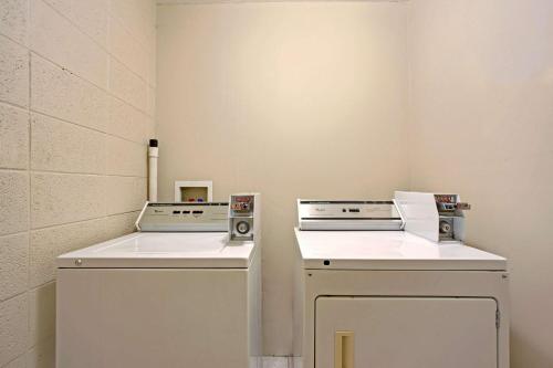 two machines sitting next to each other in a room at Super 8 by Wyndham Oklahoma/Frontier City in Edmond