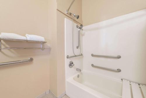 a bathroom with a shower and a bath tub at Super 8 by Wyndham Fort Worth North/Meacham Blvd in Fort Worth