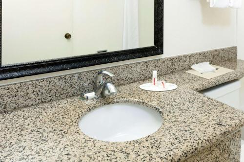 a bathroom counter with a sink and a mirror at Super 8 by Wyndham San Diego Hotel Circle in San Diego