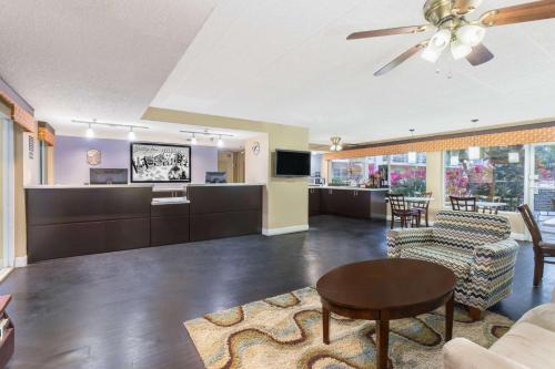 a living room with a couch and a table at Super 8 by Wyndham Ellenton Bradenton Area in Ellenton