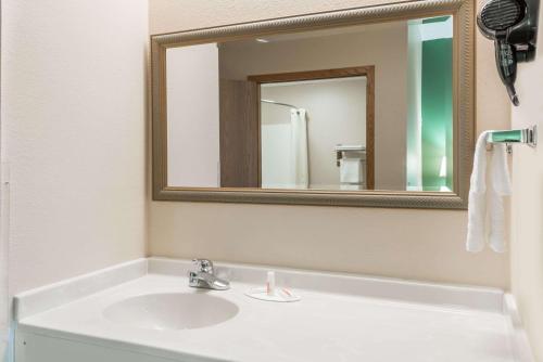 a bathroom with a white sink and a mirror at Super 8 by Wyndham Mt. Carmel IL in Mount Carmel