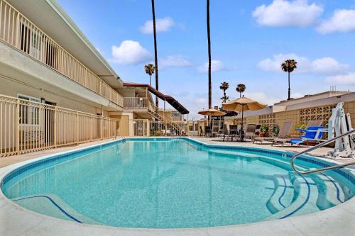
a swimming pool with a pool table and chairs at Super 8 by Wyndham Los Angeles-Culver City Area in Los Angeles
