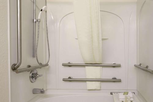 a bathroom with a tub and a shower with a mirror at Super 8 by Wyndham Corydon in Corydon