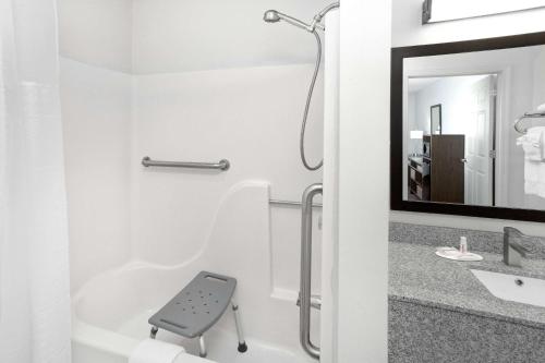 a bathroom with a shower and a sink at Super 8 by Wyndham Lafayette in Lafayette