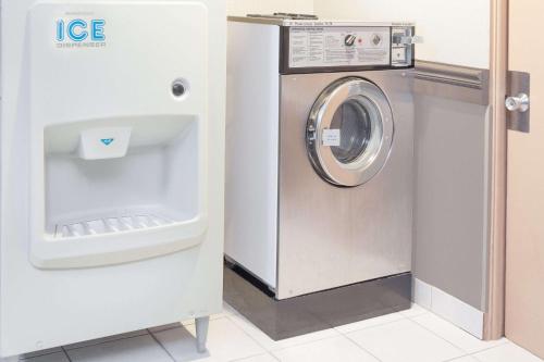 a washer and dryer in a room at Super 8 by Wyndham Morton Grove/Chicago in Morton Grove