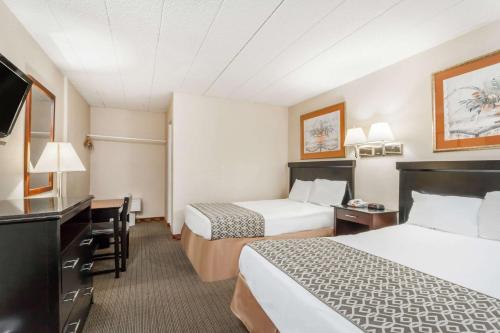 a hotel room with two beds and a desk at Atlantic Motor Inn Near Boardwalk in Atlantic City
