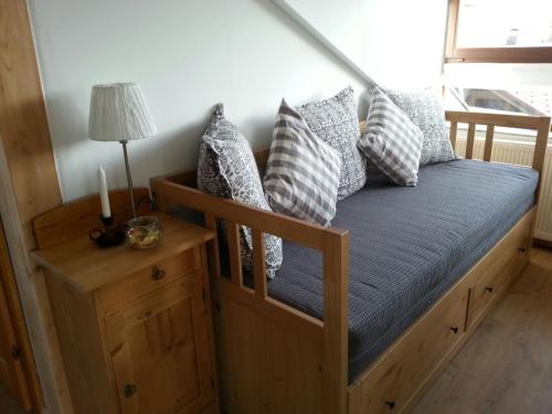 a bed with pillows on it in a room at Ferienwohnung Wiesmühlstrasse in Henndorf am Wallersee