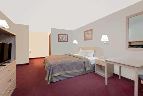 a hotel room with a bed and a desk at Super 8 by Wyndham Keystone/Mt. Rushmore in Keystone