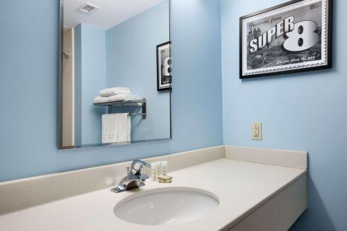 a bathroom with a sink and a mirror at Super 8 by Wyndham Pennsville/Wilmington in Pennsville