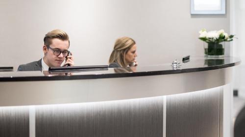 a man and a woman sitting in an office at The Barnstaple Hotel in Barnstaple