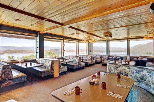 a restaurant with couches and tables and large windows at Topaz Lodge in Gardnerville