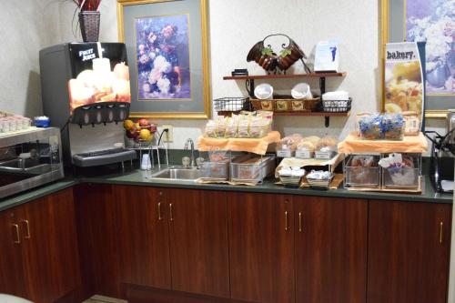 a kitchen with a counter with food and a sink at Microtel Inn & Suites by Wyndham Rock Hill/Charlotte Area in Rock Hill