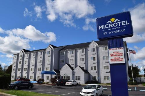 a m hotel sign in front of a building at Microtel Inn & Suites by Wyndham Rock Hill/Charlotte Area in Rock Hill