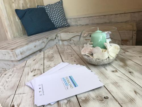 a table with a book and a candle on it at Fiumicino Airport B&B Deluxe in Fiumicino