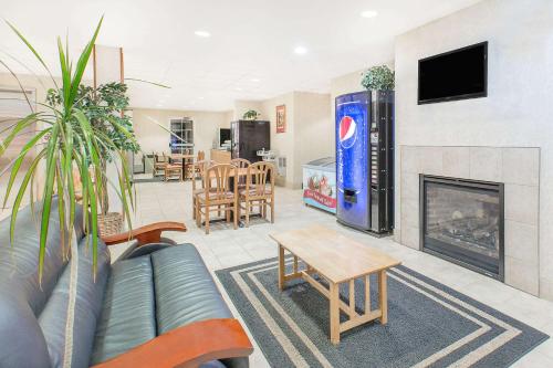 a living room with a couch and a fireplace at Microtel Inn & Suites by Wyndham Colfax in Colfax