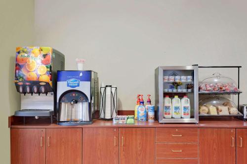 a counter with a coffee maker on top at Microtel Inn & Suites by Wyndham Wellsville in Wellsville