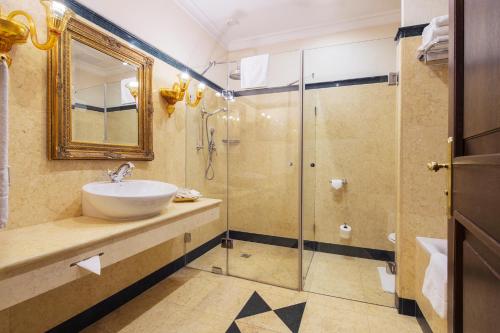 a bathroom with a sink and a shower at Arcadia Boutique Hotel in Bratislava