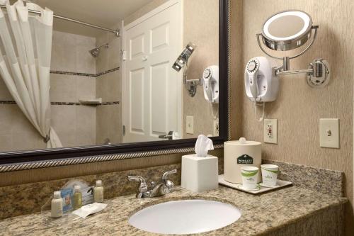 a bathroom with a sink and a mirror at Wingate by Wyndham Little Rock in Little Rock