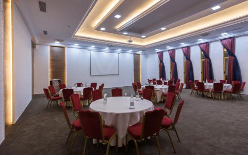 a conference room with tables and chairs and a projection screen at Africa Jade Thalasso in Korba