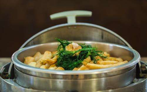 a pot of pasta with greens on top of it at Africa Jade Thalasso in Korba