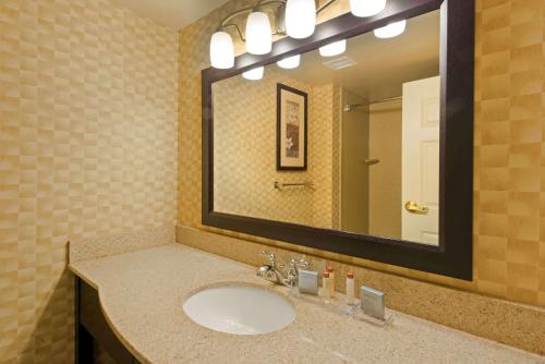 a bathroom with a sink and a large mirror at Wingate by Wyndham Erlanger - Florence - Cincinnati South in Erlanger