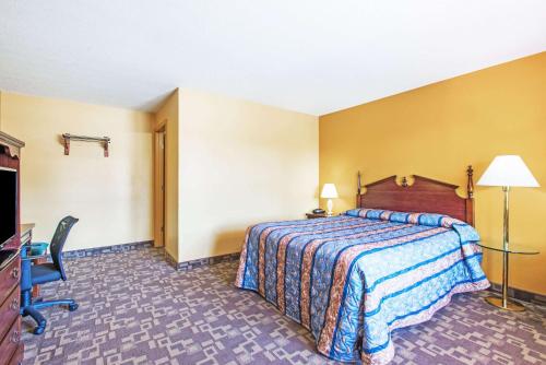 a hotel room with a bed and a desk at Knights Inn Hadley in Hadley