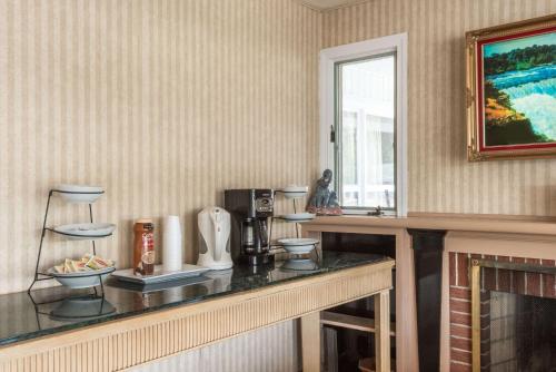 a kitchen with a counter and a fireplace at Elite Inn in Moosup