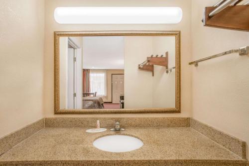 a bathroom with a sink and a mirror at Super 8 by Wyndham Sumter in Sumter