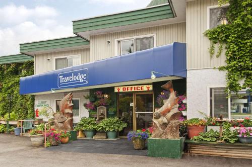 a store with plants and flowers in front of it at Travelodge by Wyndham Hope in Hope