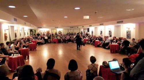a crowd of people sitting in a room with a man standing in a room at Hotel In Sylvis in Sesto al Reghena