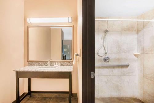 a bathroom with a sink and a shower at Super 8 by Wyndham Dilley TX in Dilley